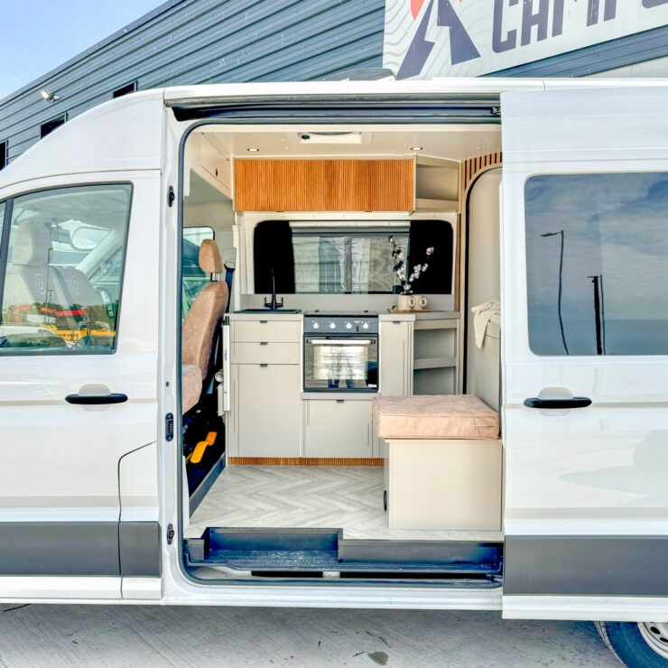 Ren - 2 Berth VW Crafter Campervan interior showing seat, oven and hob